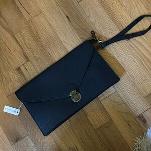Navy blue purse with a crossbody strap and a wristlet strap. Never used